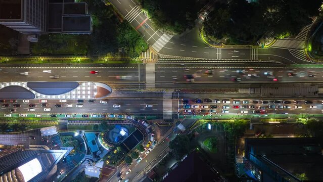 night illumination flight over jakarta city downtown traffic street aerial topdown panorama 4k timelapse indonesia