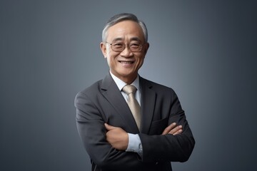 older businessman from asia, china, smiling, white hair in studio shoot