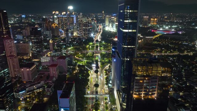 night illuminated jakarta downtown traffic street road crossroad aerial topdown panorama 4k timelapse indonesia