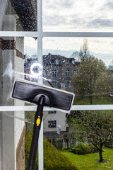 Washing the glass surface of the window with a steam generator brush