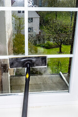 Washing the glass surface of the window with a steam generator brush