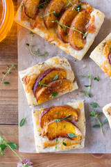 Peach pastry tarts with cheese, pepper, honey, thyme