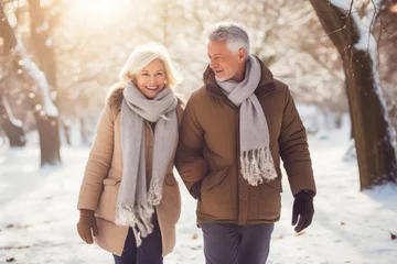 Abwaschbare Fototapete Lachsfarbe Winter Wonderland Walk: Senior Couple Embracing Cold