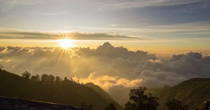 Timelapse of the sun setting over layers of rolling clouds on the mountain, taken in Mount Bromo, Indonesia	