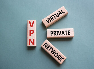 VPN - Virtual Private Network. Wooden cubes with word VPN. Beautiful grey green background. Business and VPN concept. Copy space.