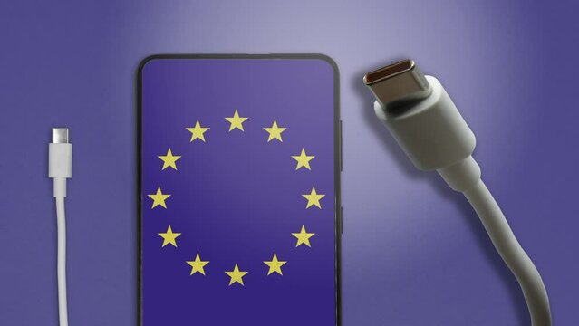 USB-C cable and a smartphone with the European Union Flag on screen