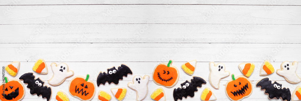 Poster halloween cookie bottom border. top view on a white wood banner background with copy space. ghosts, 