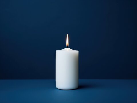 Capture the essence of solitude with a lone candle on a deep blue background, evoking a sense of calm and reflection