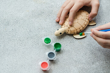 Kid's hands with turtle toy