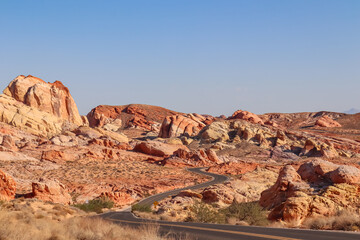 Panoramic view of endless winding empty road in Valley of Fire State Park leading to red Aztec...