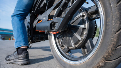 Close-up of the rear wheel with the engine of an electric motorcycle.