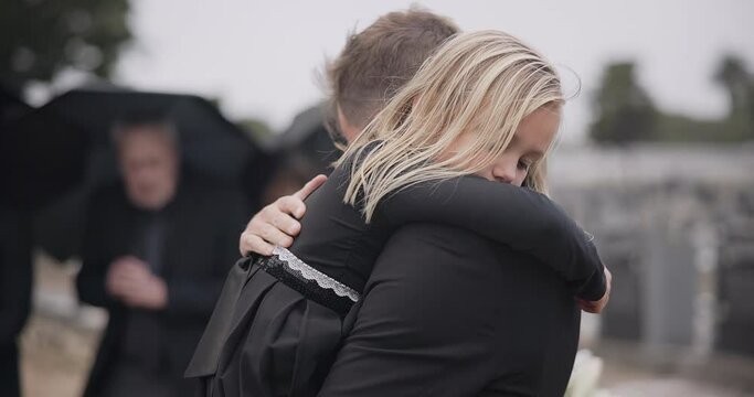 Sad, death and a girl with her father at a funeral for grief or mourning loss together outdoor. Family, empathy and a man holding his daughter at a memorial service or ceremony for condolences