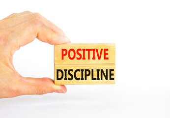 Positive discipline symbol. Concept words Positive discipline on beautiful wooden blocks. Beautiful white background. Businessman hand. Business psychology positive discipline concept. Copy space.