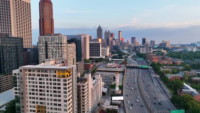 Drone footage of highways and buildings in Atlanta near Atlantic Station shot in 4k. Sideways pan of skyline in Atlanta at sunset. Close up shot o the buildings with sun reflection on buildings.