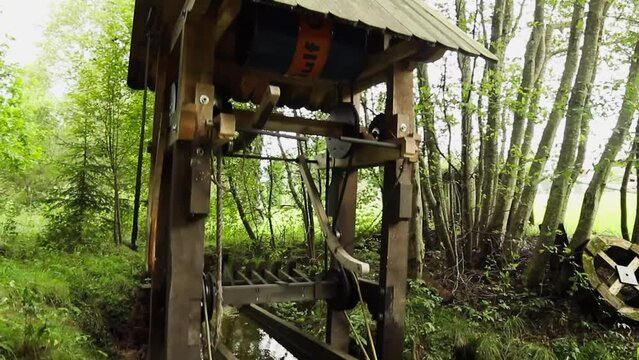 steadicam medium shot of decorative useless mechanical bird wings moving mechanism moved by falling water