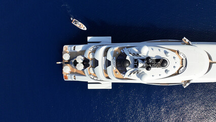 Aerial drone top down photo of latest technology mega yacht luxurious wooden stern anchored in deep...