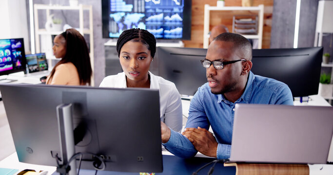 African Financial Data Analysts Using Dashboard On Screens