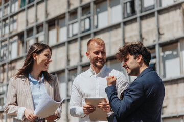 Businessman celebrating good news while working with his partners remotely