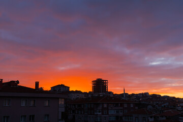 Fototapeta na wymiar Delightful sunrise sky with clouds over apartment, residential buildings of Istanbul. City is slowly awakening. Urban, early morning and cityscape concept