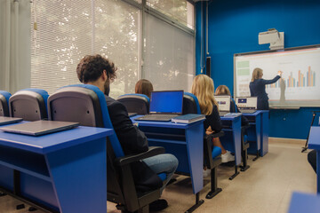 Fototapeta premium Male student using smart phone during classes at school.