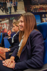 Beautiful, satisfied, successful female college students attending classes. Smiley students listening lecture at school.