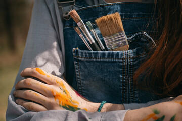 Close up of overalls with brushes
