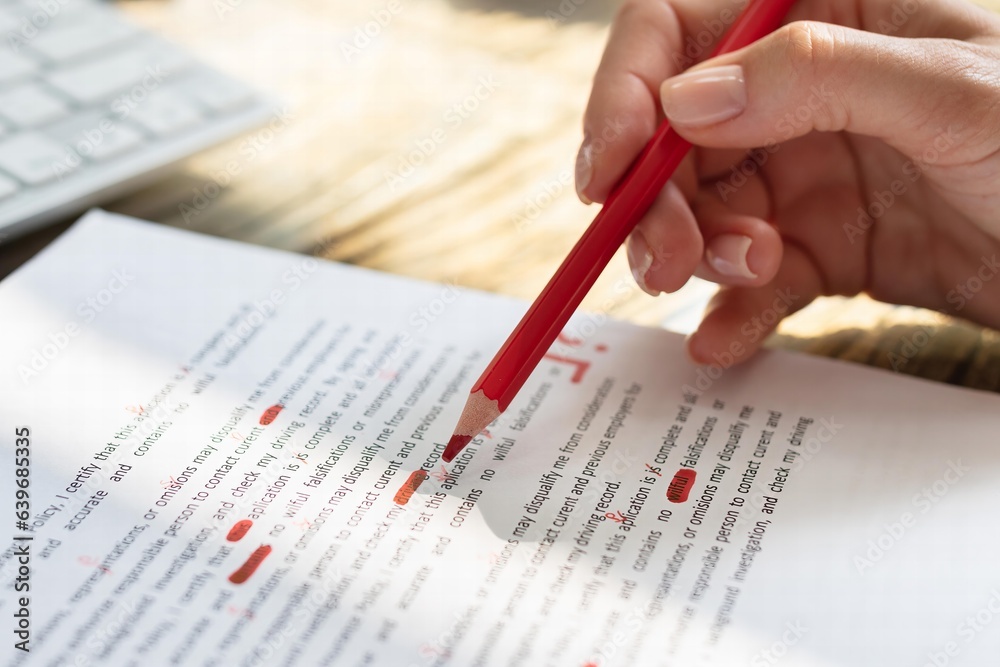 Poster person marking error with red marker