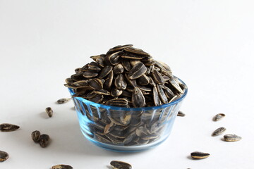 organic sunflower seeds in bowl isolated on white background