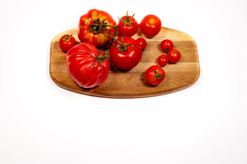 fresh tomatoes from the home garden displayed on a wooden board