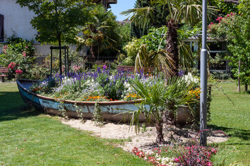 An old boat turned into a flower bed on the embankment