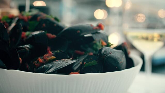 Black mussels with vegetable sause and a glass of white wine