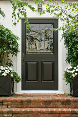 beach cottage with black front door and beveled glass