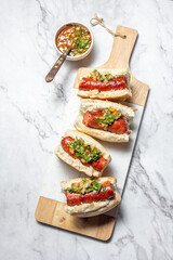 Chilean and Argentinian food. Traditional choripan with spicy pebre, chorizo sandwich with chorizo sausages and bread.