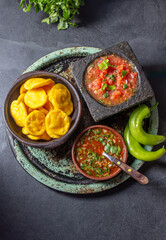 Sopaipilla. Latin American food. Traditional chilean homemade pumpkin sopaipillas with typical salsas - chancho en piedra tomato sauce in stone mortar and spicy pebre