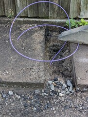 Fibre optic cable in a trench waiting to be installed into a home hook up box outside a property. UK gigabit broadband rollout being installed by internet service providers across the country. - obrazy, fototapety, plakaty