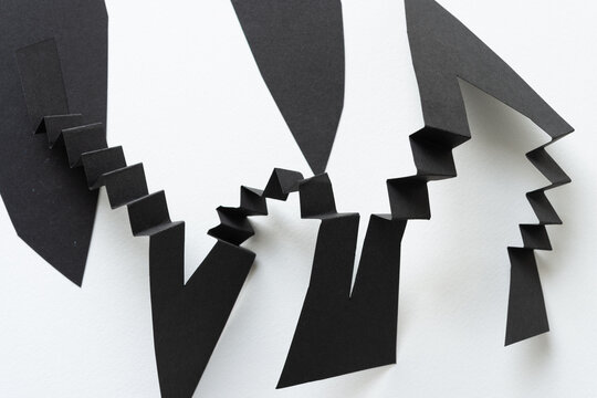 black paper ribbon with geometric or angular edges and folded elements on white paper