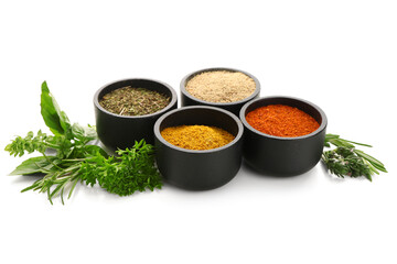 Bowls with spices and fresh herbs isolated on white background