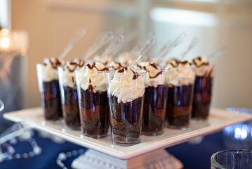 Mini parfait-mini dessert glass cylinder cups filled with chocolate, fudge and topped with whipped cream