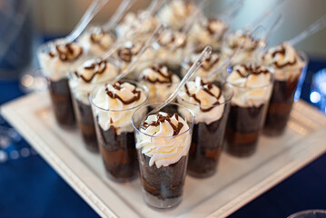Mini parfait-mini dessert glass cylinder cups filled with chocolate, fudge and topped with whipped cream