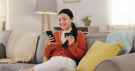Foto auf Acrylglas Schönheitssalon Happy woman, credit card and phone on couch online shopping, ecommerce and fintech easy payment. Asian person in China typing bank information on cellphone for discount or finance transaction at home