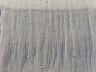Beach sand wave pattern created by wind and waves