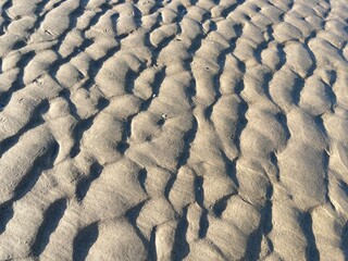 Beach sand wave pattern created by wind and waves