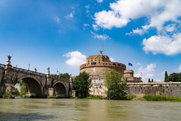 Fototapeta premium Castel Sant'Angelo and Ponte Sant'Angelo, in Rome, Italy, from the banks of the river tiber on a summers day