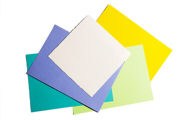  A pile of multi-colored paper for creativity: yellow, white, purple, green, blue. View from above