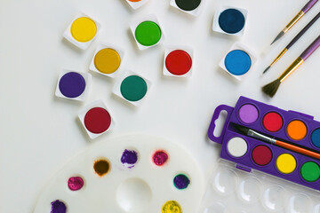 Colorful watercolor with paintbrush on white surface.Education concept