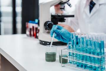 Chemologist explains examining blood in test tube. Examples of drugs for treatment of hematological diseases, blood diseases refer to diseases, disorders of the hematopoietic system, immune system