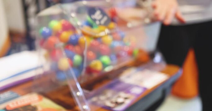 Process of prize drawings, extracting a winning numbers of lottery machine, raffle drum with a bingo balls, bingo machine and winning tickets on event with a host, hands on lottery machine