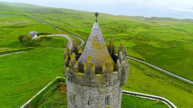 Doonagore Castle aerial foggy orbit view, iconic landmark, County Clare, Ireland