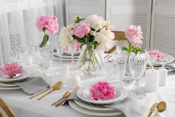 Stylish table setting with beautiful peonies in dining room