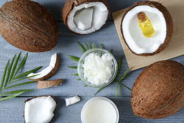 Flat lay composition with organic coconut cooking oil on grey wooden table